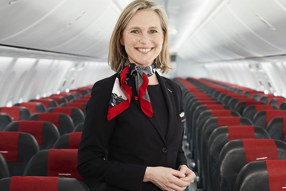 stewardesse-in-cabin-smiling-960x640